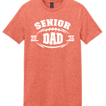 A heathered coral orange short-sleeve t-shirt with a white graphic print on the front that reads 'SENIOR DAD' with a football motif and the years '2026' on either side.